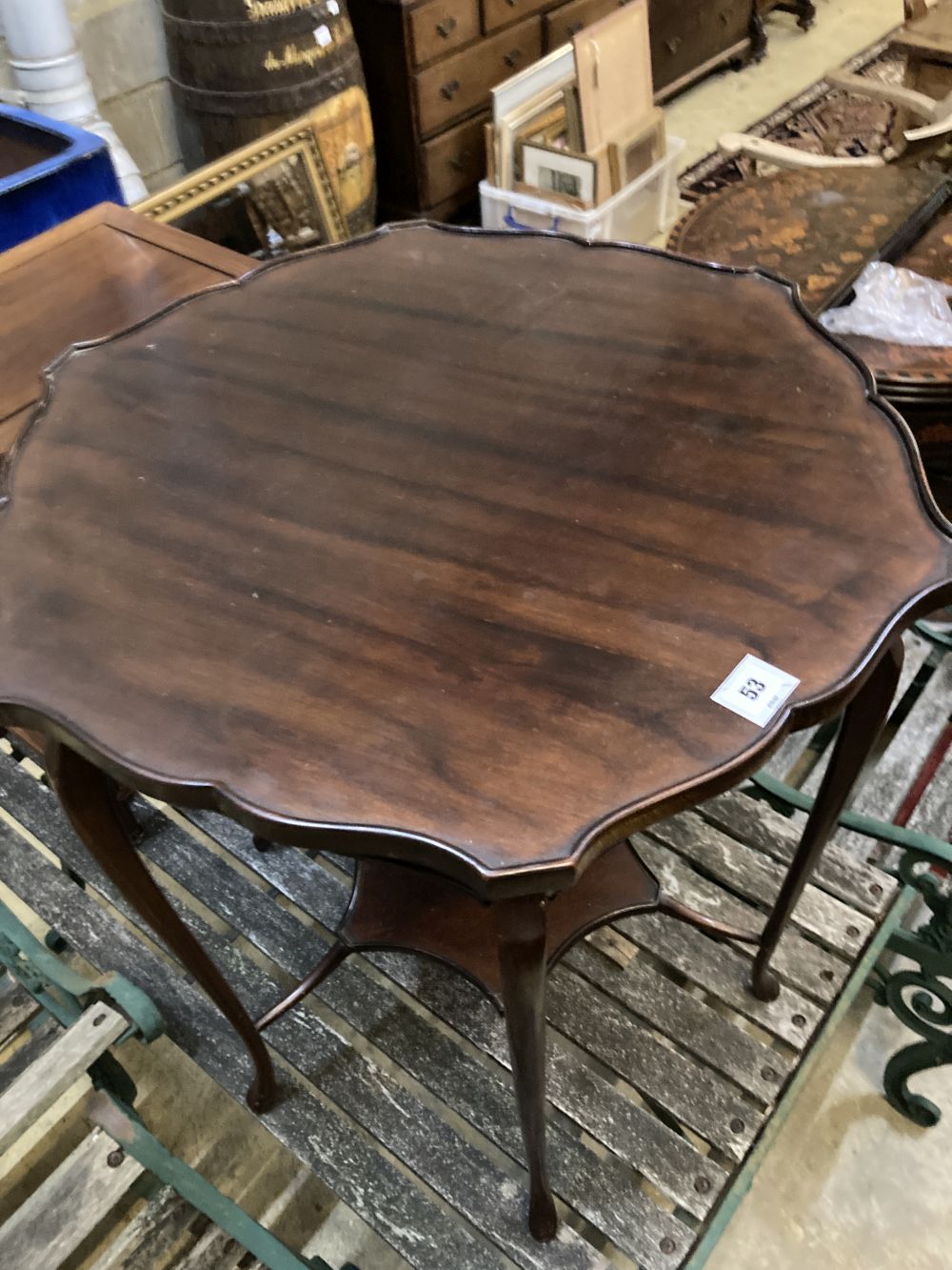 A late Victorian mahogany shaped circular topped two tier table, 67cm diameter, 72cm high
